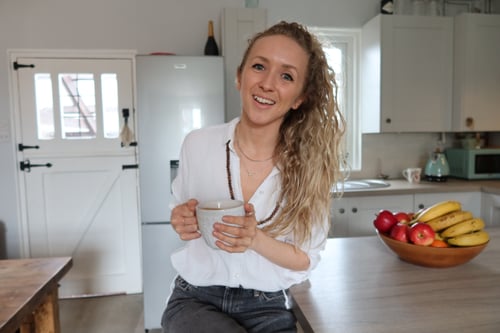 Rosemary Martin, plant-based vegan dietitian sitting with cup of tea