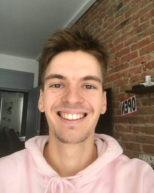 a selfie where main smiling and watching in the camer