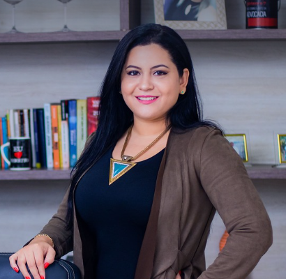 Pauline Jones founder of Inkwell Office Supplies, stands in front of my bookshelf in her office, where she creates top-notch stationery products