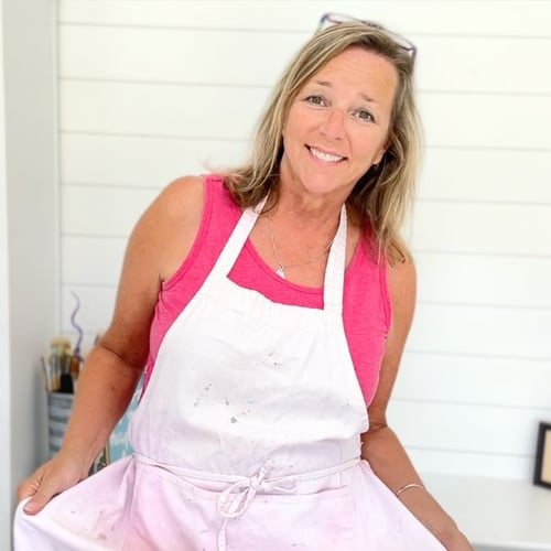Mona Schmitt of Craft Klatch smiling in an apron