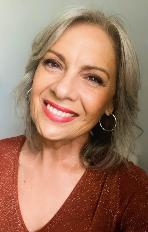 Face of a smiling woman after head and neck cancer treatment