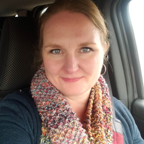 Talena Winters wears a textured scarf and smiles at the camera.