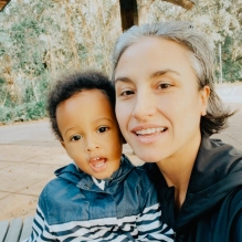 An image of a mom and her small child smiling.