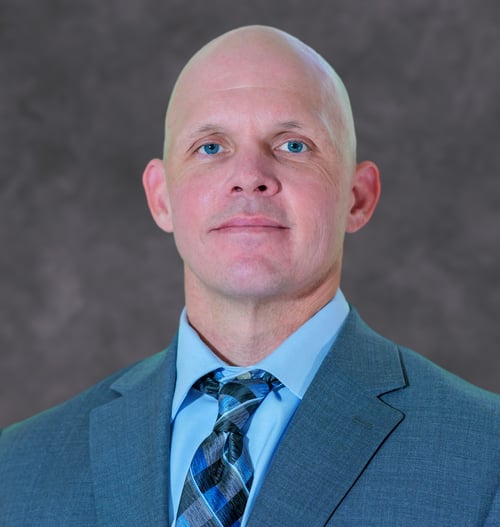 Headshot of Death Investigator and Bloodstain Pattern Analyst Jeffrey Gentry in front of grey background