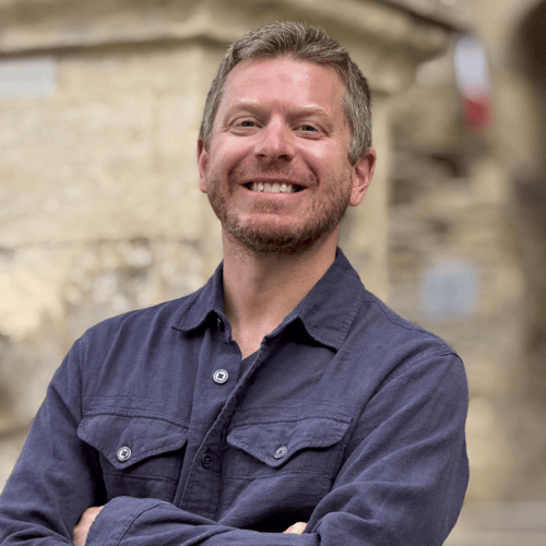 hungry hiker rory moulton stands in front of a fountain in france