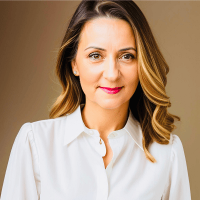 Headshot of Bee Kingshott, owner of Bee Assured Business Solutions. Wearing professional shirt with a warm toned background