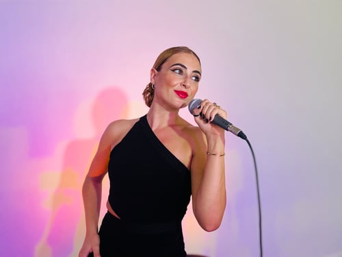 Eva Evangelou Singer Headshot with Mic