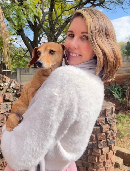 A Dog Mom/Parent holding her Dachshund.