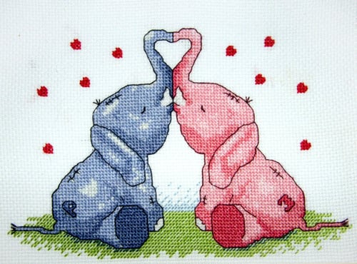 completed cross stitch depicting 2 elephants, with heart motifs