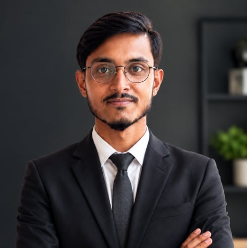 Mortuja Islam, founder of MI VENTURES, wearing a professional black suit and glasses.