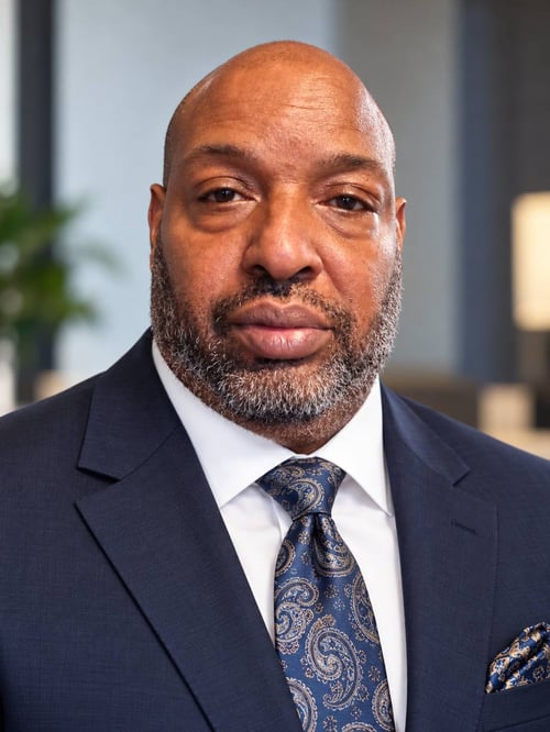 Antwaune Williams, digital creator and author, wearing a professional navy-blue suit. Creator of personal growth ebooks and digital learning resources focused on discipline, productivity, and success.