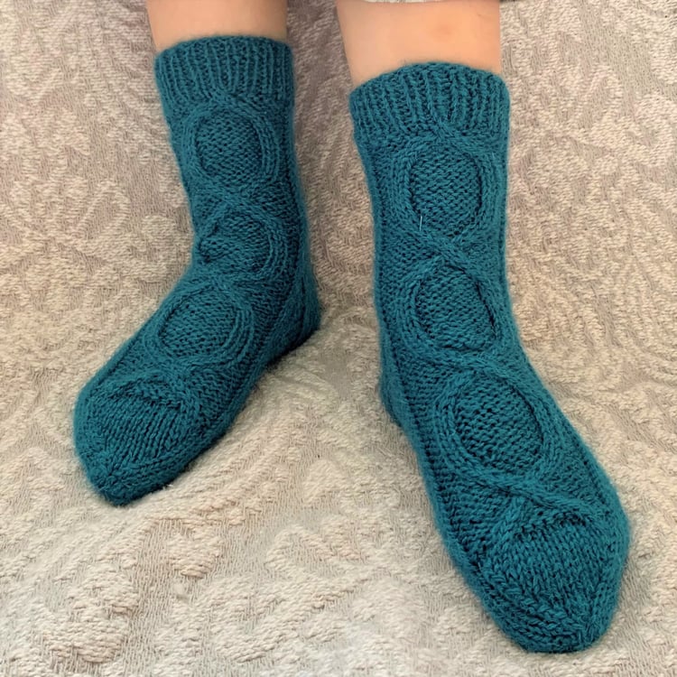 Hand knit wool socks in child size. Knitting pattern in sizes from baby to adult. Designed in the UK by Su Sayer