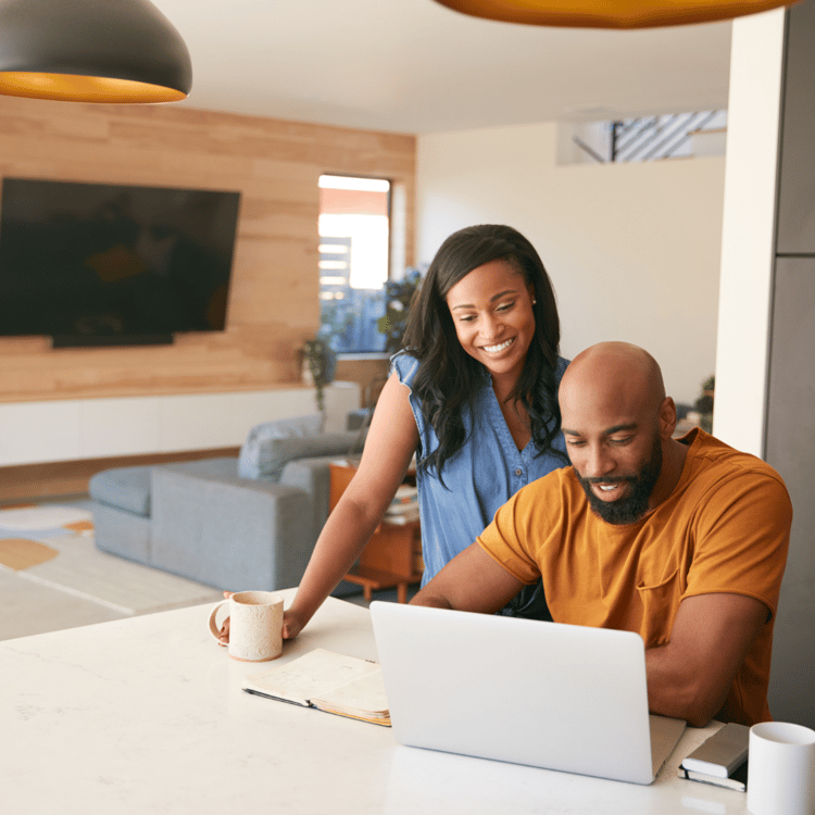 Black couple doing financial planning on a computer