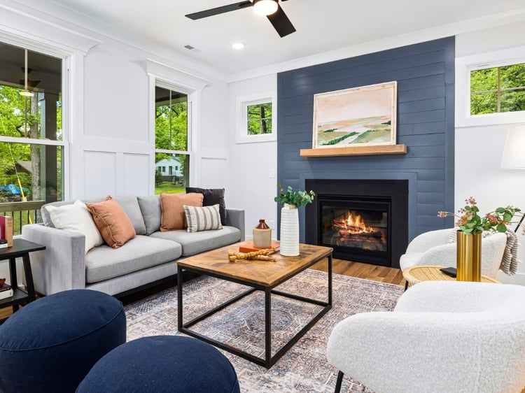 How to choose an accent wall. A muted blue fireplace wall in this living room. Coordinating paint color palettes by Lavenia Shash.