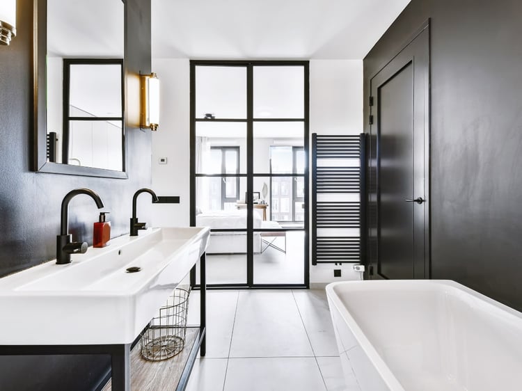 How to choose an accent wall. Two walls opposite each other painted in a stunning black in this bathroom. Coordinating paint color palettes by Lavenia Shash.