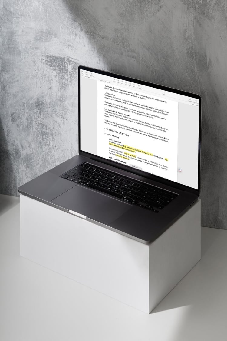 A laptop computer with pre-written, customizable music studio contract on screen