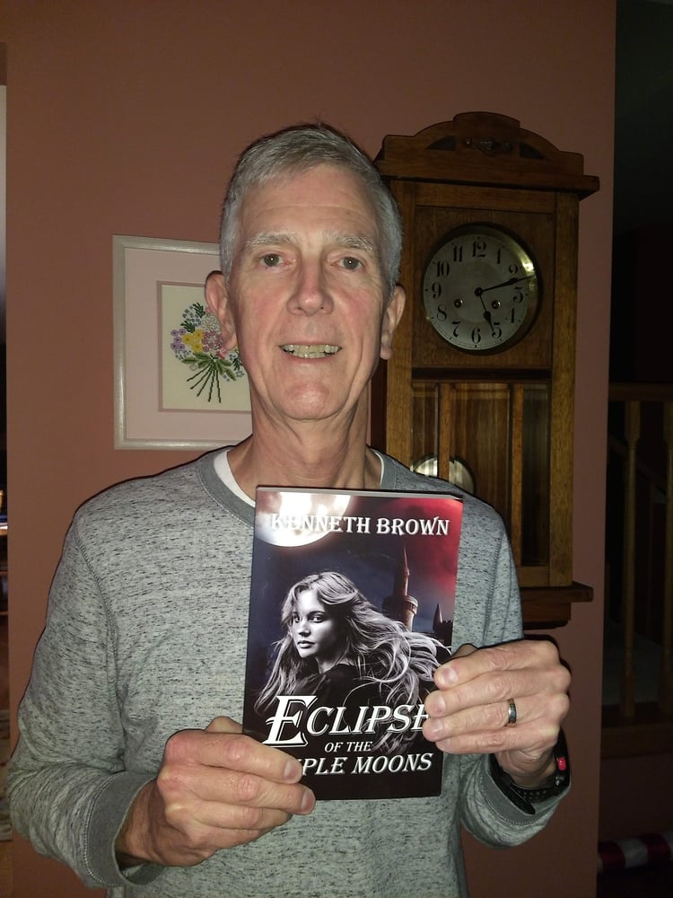 Kenneth Brown Author Covering up the title of Eclipse of the Triple Moons Paperback.