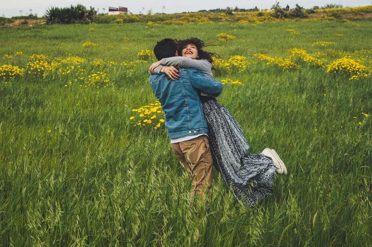 young couple embracing in pastoral scene