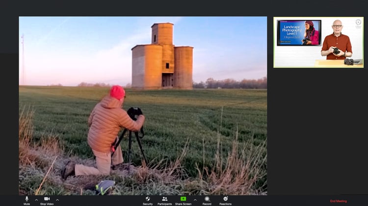 A student live zooms as he sets up a sunrise landscape shot in front of an abandoned grain elevator in Kansas.