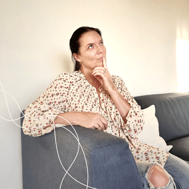 woman sitting on a sofa thinking