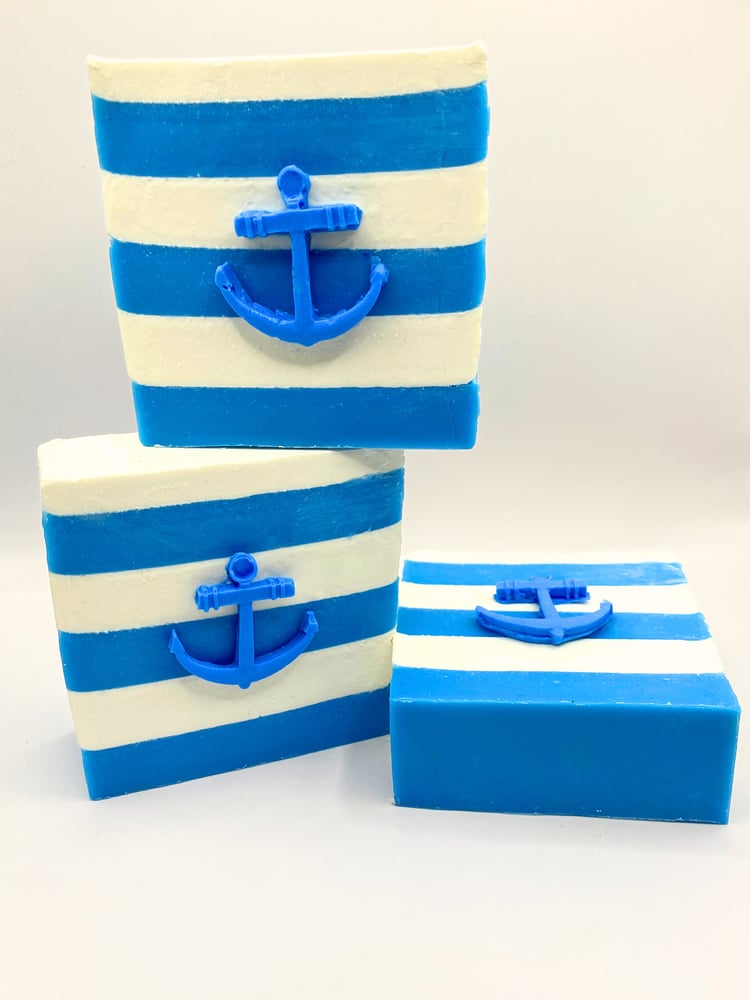 Nautical handmade soap. Three blue and white striped soap bars with anchors on the front