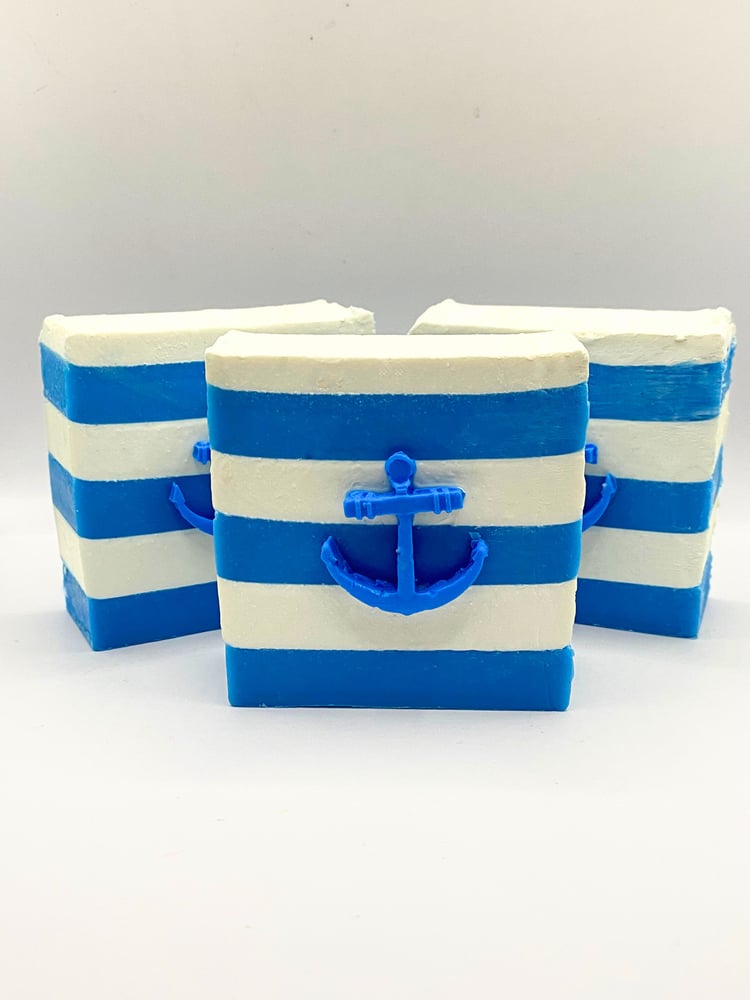 Nautical handmade soap. Three blue and white striped soap bars with anchors on the front