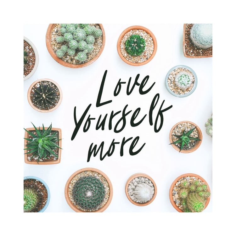 Love yourself more text with plants surrounding it for article about 17 habits for more happiness