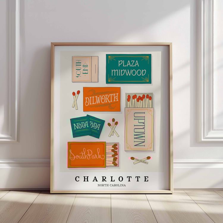 A framed picture of Charlotte, North Carolina neighborhoods drawn in various lettering styles on matchboxes. Artwork has a blue and orange color scheme