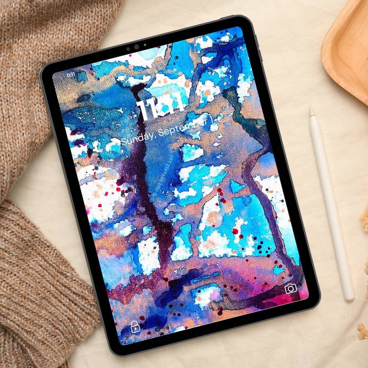 Tablet wallpaper featuring deep blues, dark teals, and gold metallic highlights in an abstract cosmic-inspired nebula design.