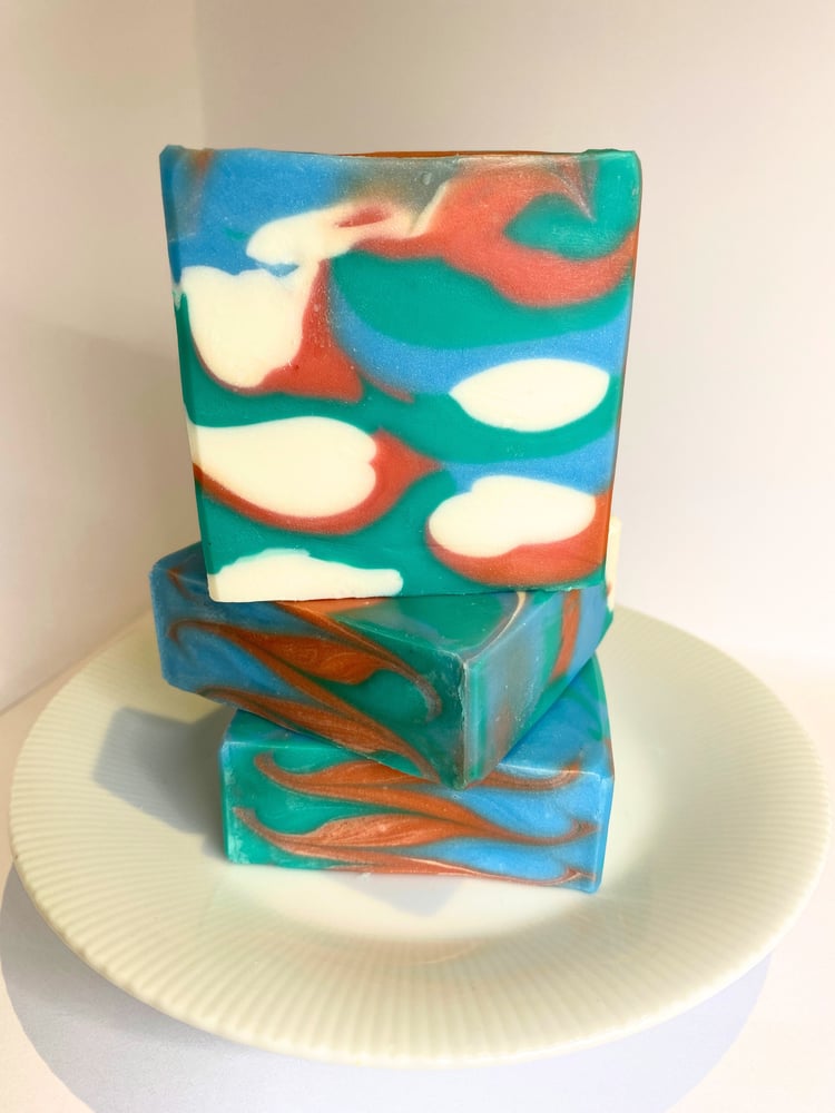 Handmade soap swirled with blue, green, orange, and white