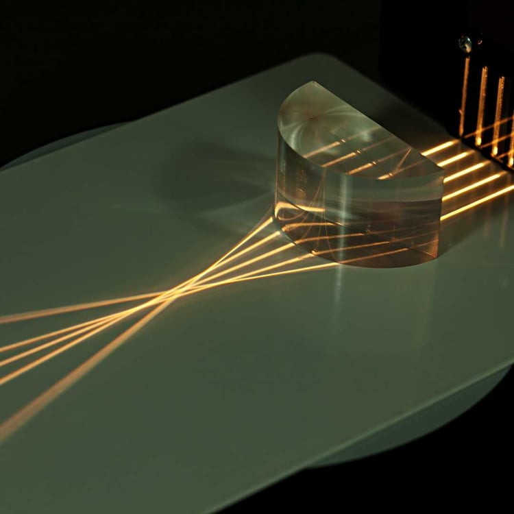 an image of a laser lens being focused on a material in this section