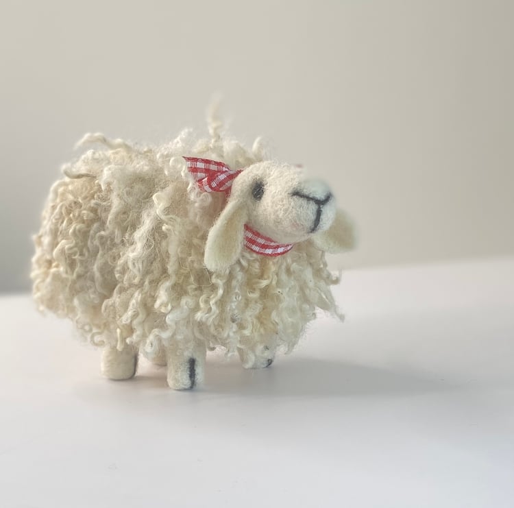 picture of a needle felted sheep with a curly coat