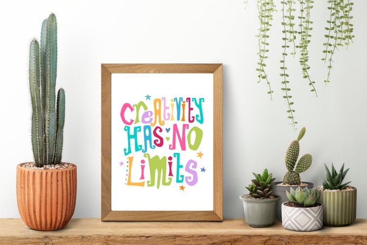 A downloadable print with a hand lettered design which says ‘creativity has no limits’ in a range of bright colours.