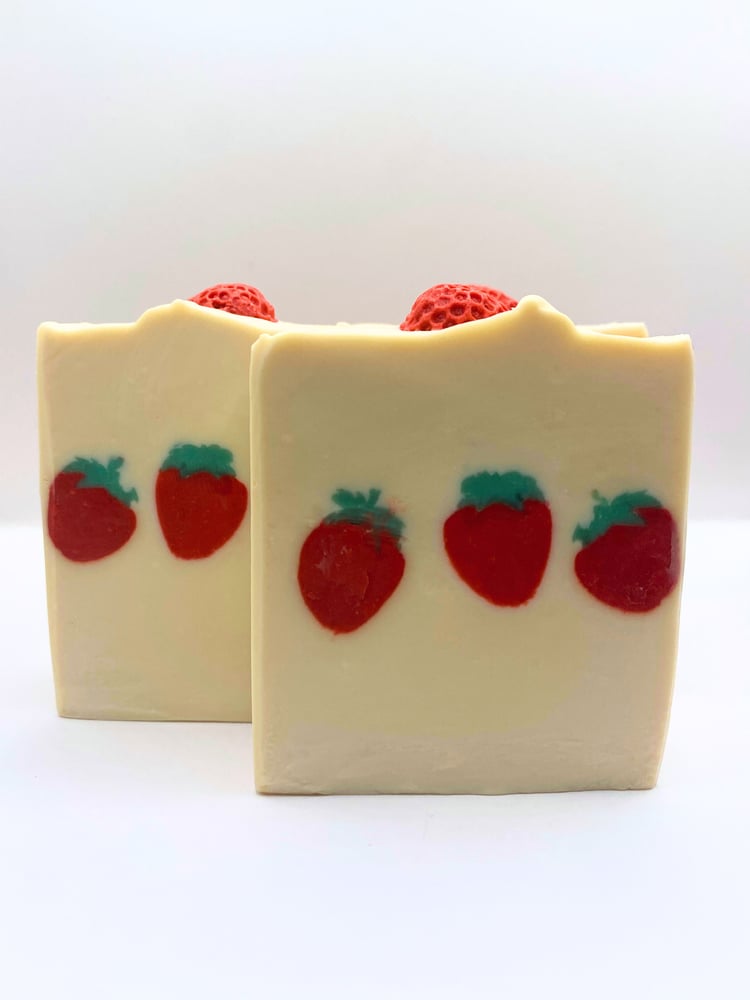 U-Pick Strawberry handmade soap smells like berries. The design features three strawberries through the middle of the soap and another strawberry sits on top