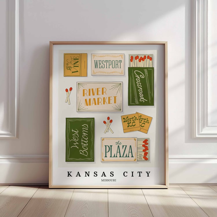 A framed picture of Kansas City, Missouri neighborhoods drawn in various lettering styles on matchboxes. Artwork has a green, yellow, white and blue color scheme