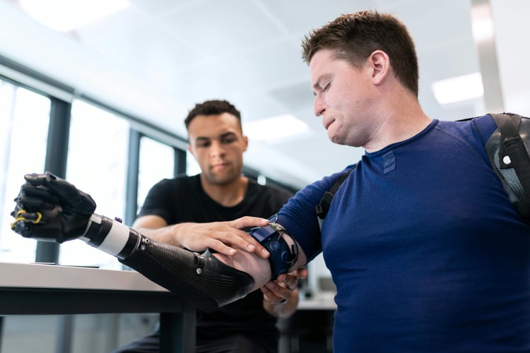 a man being fitted with a computerized prosthetic arm