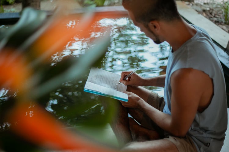 Yoga teacher Tristan writing in a notebook