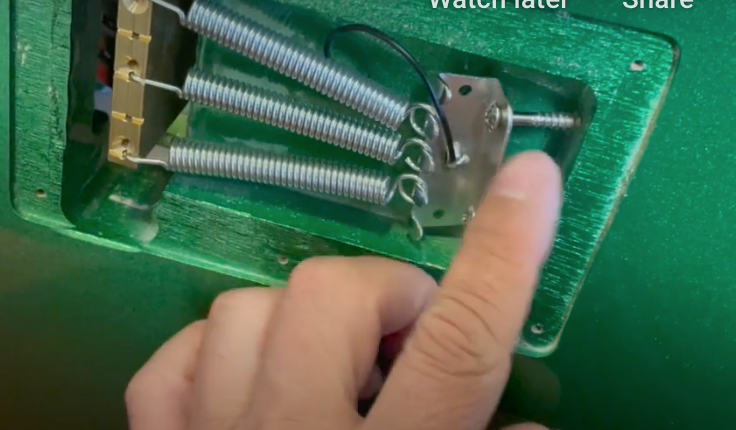 bridge springs in the back of an electric guitar