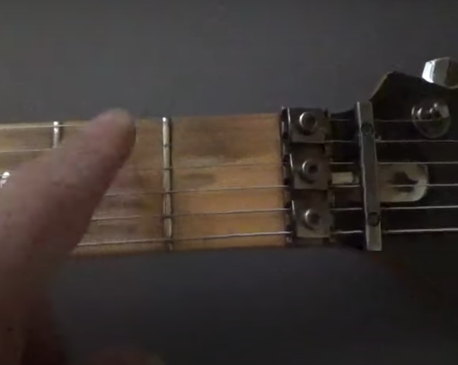 electric guitar fretboard fret buzz