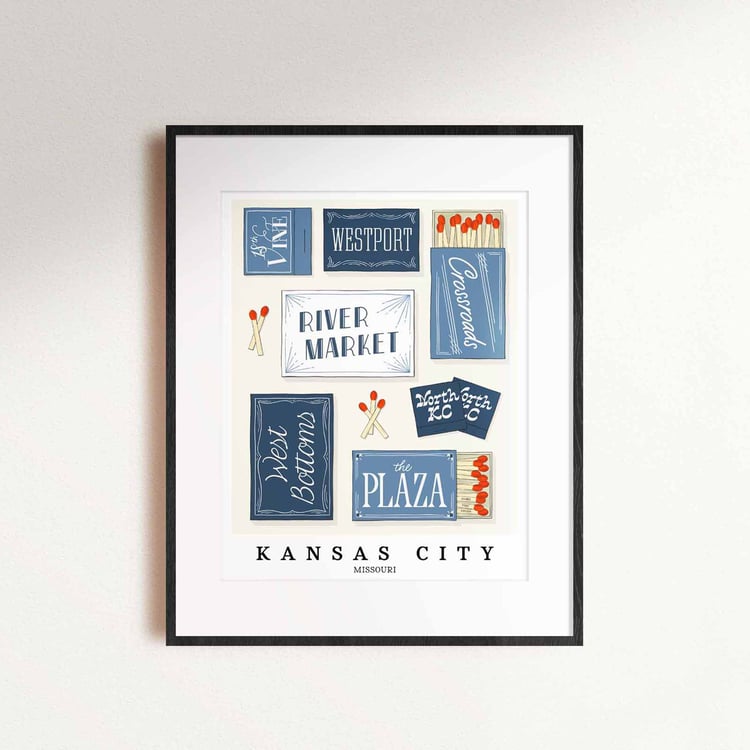 A framed picture of Kansas City, Missouri neighborhoods drawn in various lettering styles on matchboxes. Artwork has a blue and white color scheme