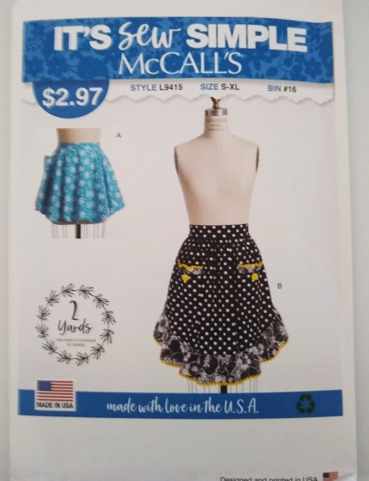 McCall’s L9415 sewing pattern envelope showing two styles of misses’ half aprons with rounded or ruffled hems, labeled It’s Sew Simple, in sizes S to XL