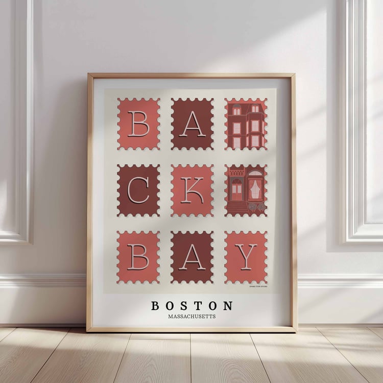 A framed picture of postage stamps featuring the Back Bay neighborhood in Boston, Massachusetts drawn in a unique lettering style. Artwork has a pink, burgundy and gray color scheme