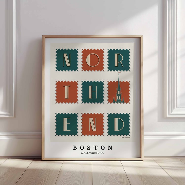 A framed picture of postage stamps featuring the North End neighborhood in Boston, Massachusetts drawn in a unique lettering style. Artwork has a orange, green and beige color scheme