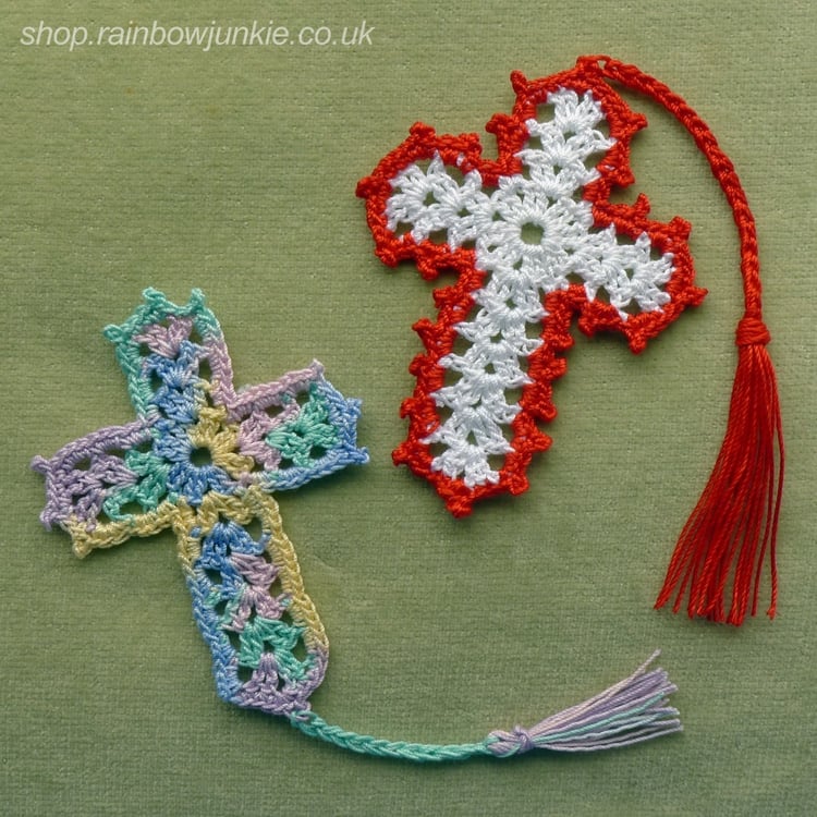 Two dainty cross bookmarks showing two different styles: one made in a multicolour cotton thread, the other in white with a red edging. Both have cords and tassels.