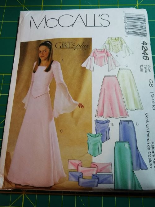 McCall’s 4246 sewing pattern from 2003 for Girl’s and Girl’s Plus semi-fitted tops, slightly flared skirts, and stoles in sizes 12–16, featuring princess seams, button closure, and formal styling, shown on illustrated envelope.