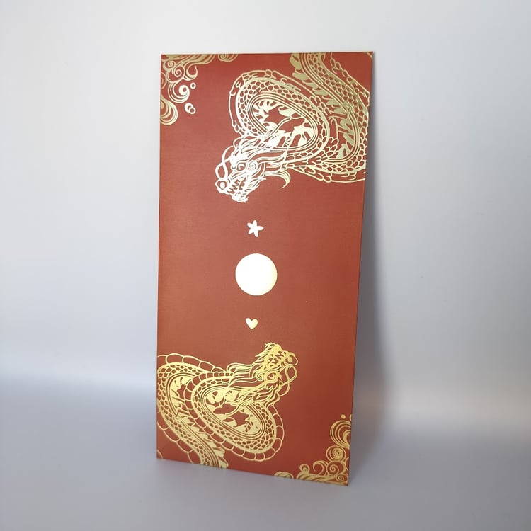 A wedding hongbao with a red background and two ornate dragons heading towards each other. The middle of the hongbao has a moon with a star and heart. Wave details are on the top left and bottom right corners.