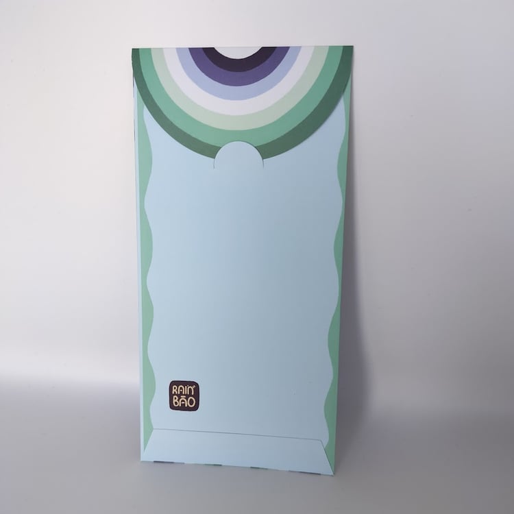 Back of a pastel money envelope with purple, blue, and green rainbow arc pattern on the closing flap.