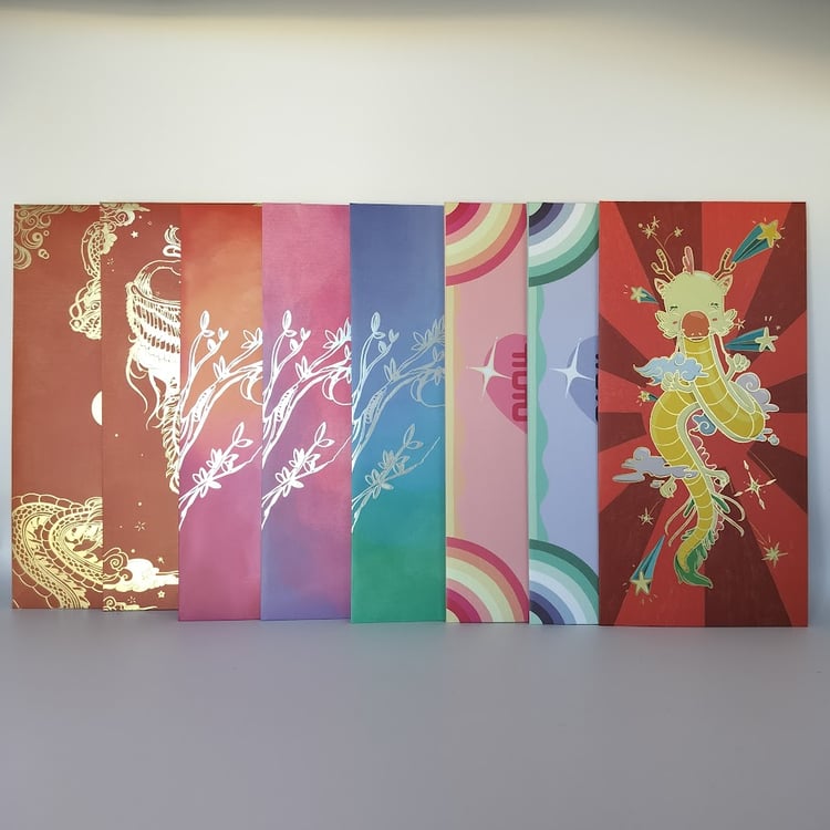 Row of Chinese money envelopes (hongbao) displaying various designs - red envelopes with gold dragon and phoenix foil, gradient envelopes with silver botanical designs, rainbow striped envelope with double happiness symbol.