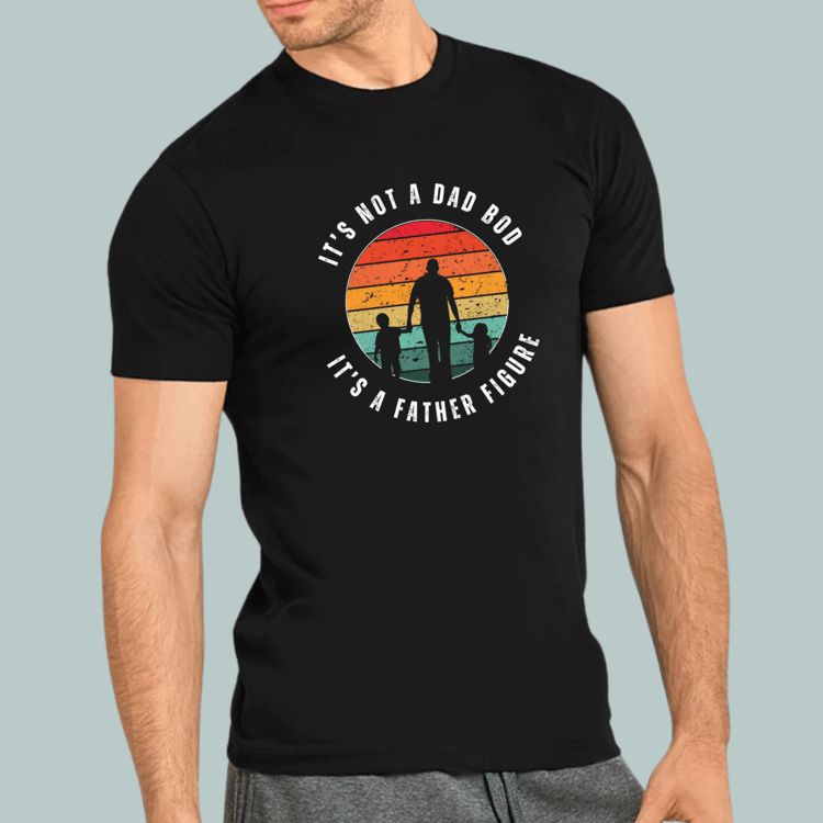 A man wearing a black t-shirt featuring a retro sunset silhouette design with the text "It’s Not a Dad Bod It’s a Father Figure" – perfect for Father’s Day gifts or dad-themed apparel.
