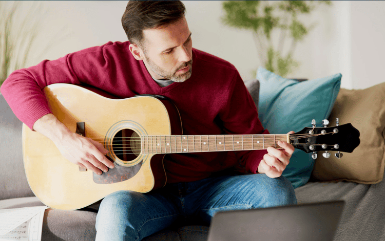 adult practicing guitar